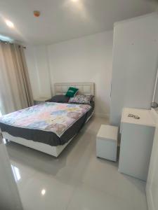 a bedroom with a bed with a laptop on it at wongwian N in Ban Bo Khaem