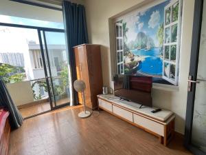 a living room with a flat screen tv on a stand at 846B50 BÌNH GIÃ in Vung Tau