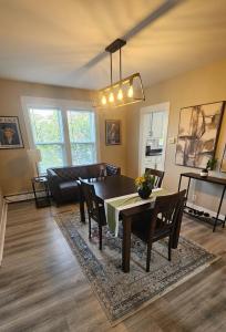 a dining room and living room with a table and chairs at Cozy One Bedoom apartment in Saint John