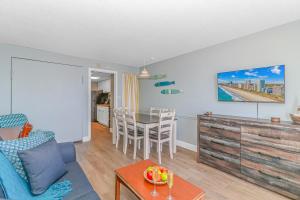 a living room with a table and a couch at Boardwalk 1139 & 1140 in Myrtle Beach