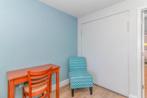 a dining room with a table and a chair at Boardwalk 1139 & 1140 in Myrtle Beach