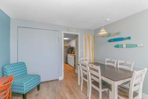 a kitchen and dining room with a table and chairs at Boardwalk 1139 & 1140 in Myrtle Beach +49 photos