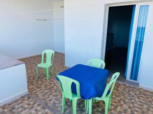 a table and two chairs with a blue cloth on it at Résidence R in Salakta