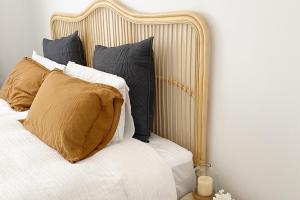 a bed with four pillows on top of it at Herea Bunker in Turangi +2 photos