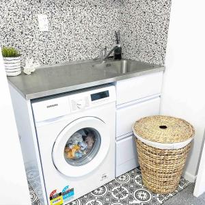 a washing machine in a bathroom with a sink at Herea Bunker in Turangi