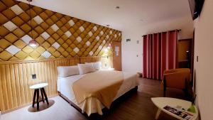 a bedroom with a large bed with a wooden wall at Hotel Casa Jima Agave in Tequila +57 photos