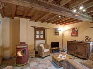 a living room with a fireplace and a tv at Gîte de charme rénové 3 épis, 2 chambres en pleine nature - FR-1-496-92 in Palogneux