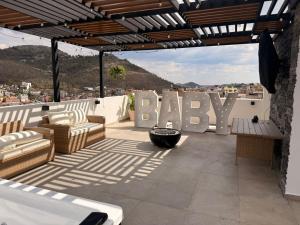 a patio with a sign that says baby on it at Apartamento Maywood in Zacatecas +8 photos