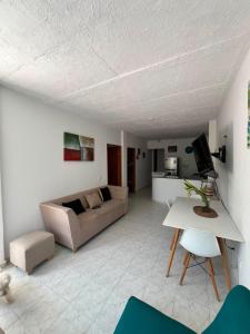 a living room with a couch and a table at Apartamentos Rincón Garcia in Cartagena de Indias