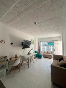 a living room with a table and chairs and a couch at Apartamentos Rincón Garcia in Cartagena de Indias