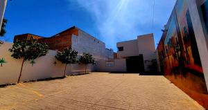 an empty alley with trees in front of a building at Hotel Casa Jima Agave in Tequila