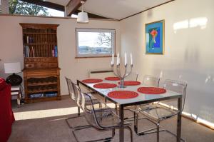 a dining room with a table and chairs at Oystershell Lodge in Otter Ferry