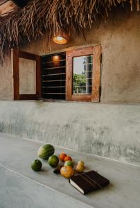 a pile of fruit sitting on a table with a window at Lahara - Komari in Ampara