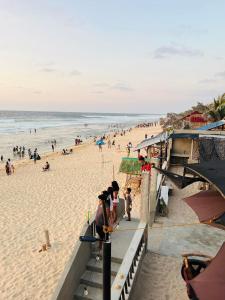 a group of people on a beach with the ocean at R-M Beach Resort in Bolinao