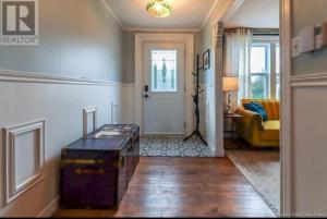 a hallway with a room with a door and a couch at Central, Dog Friendly, Parking in Saint John