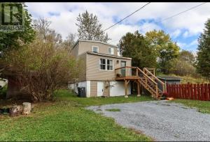 a house with a porch and a wooden deck at Central, Dog Friendly, Parking in Saint John