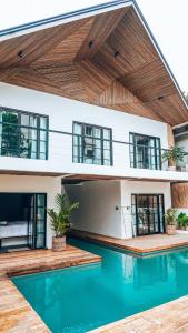 a house with a swimming pool in front of it at Bliss Villa By Happiness Philippines in El Nido