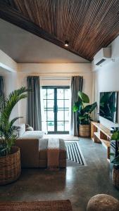 a bedroom with a bed and a large window at Bliss Villa By Happiness Philippines in El Nido