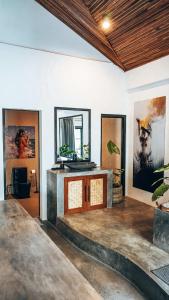 a living room with a fireplace and a wooden ceiling at Bliss Villa By Happiness Philippines in El Nido