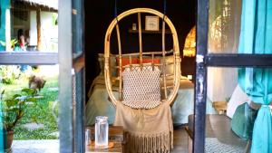 a rattan chair sitting on a table in a room at Happiness Villas in El Nido