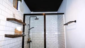 a shower with a glass door in a bathroom at Happiness Villas in El Nido +65 photos