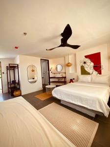 a bedroom with a bed and a ceiling fan at Happiness Hostel Boracay in Boracay