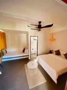 a hotel room with two beds and a mirror at Happiness Hostel Boracay in Boracay
