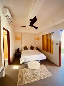 a bedroom with a bed and a ceiling fan at Happiness Hostel Boracay in Boracay +38 photos