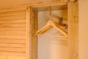 a wooden closet with a hanger in a room at Happiness Hostel Siargao in General Luna