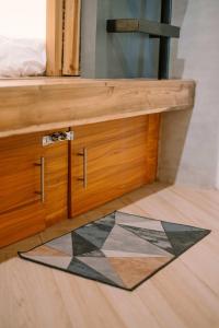 a wooden drawer with a mosaic floor in a room at Happiness Hostel Siargao in General Luna