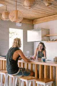two women sitting at a counter in a kitchen at Happiness Hostel Siargao in General Luna +55 photos