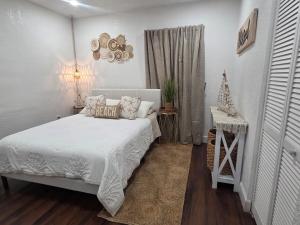 a bedroom with a white bed and a window at Varadero Magical Scape in Miami
