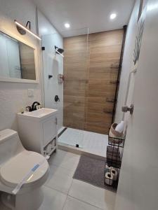 a bathroom with a shower with a toilet and a sink at Varadero Magical Scape in Miami +54 photos