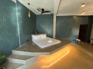 a bath tub in a room with a green wall at Happiness Kulambo Villa El Nido in El Nido +46 photos