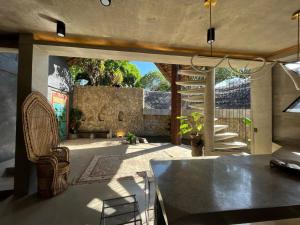 a living room with a table and a chair at Happiness Kulambo Villa El Nido in El Nido
