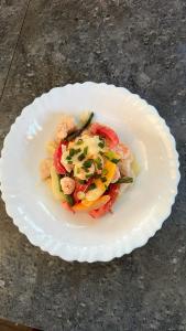 a white plate of food on a table at La Petite Maison in Antsiranana +59 photos