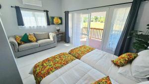 a living room with a bed and a couch at Mama's Mountain Views in Avarua