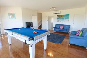 a living room with a pool table and couches at '128 The Esplanade' - Beachside holiday home with swimming pool in Robe in Robe