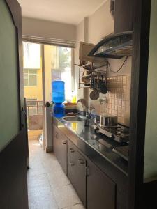 a kitchen with a sink and a counter top at Soaltee city apartments in Kathmandu