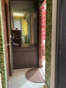 a bathroom with a large mirror and a brown door at Soaltee city apartments in Kathmandu +7 photos