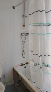 a bathroom with a bath tub and a shower curtain at AAA lodge in Middlesbrough