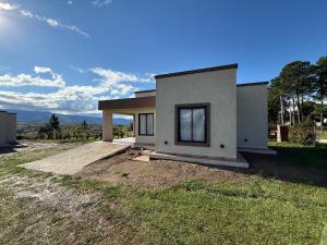a rendering of a house in a field at El Tesoro de Yacanto in Villa Yacanto