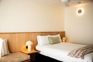 a hotel room with a bed and a couch at HaKu in Brunswick Heads