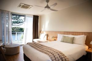 a hotel room with a large bed and a window at HaKu in Brunswick Heads