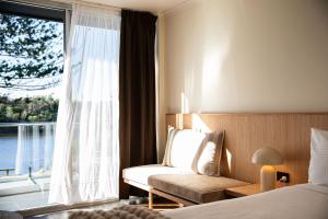 a hotel room with a bed and a window at HaKu in Brunswick Heads