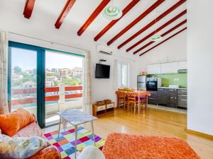 a living room with a couch and a table at Alluring Apartment by the Sea in Stomorska