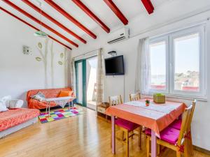 a living room with a table and a couch at Alluring Apartment by the Sea in Stomorska