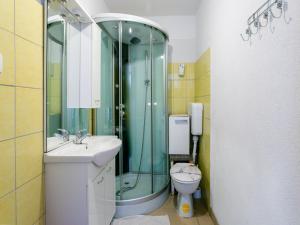 a bathroom with a shower and a sink and a toilet at Alluring Apartment by the Sea in Stomorska +32 photos