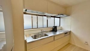 a kitchen with a sink and a window at Tabinoteitaku 和-WA- in Sendai +24 photos
