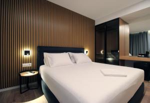 a bedroom with a large white bed in a room at Valmar Hotel in Ksamil
